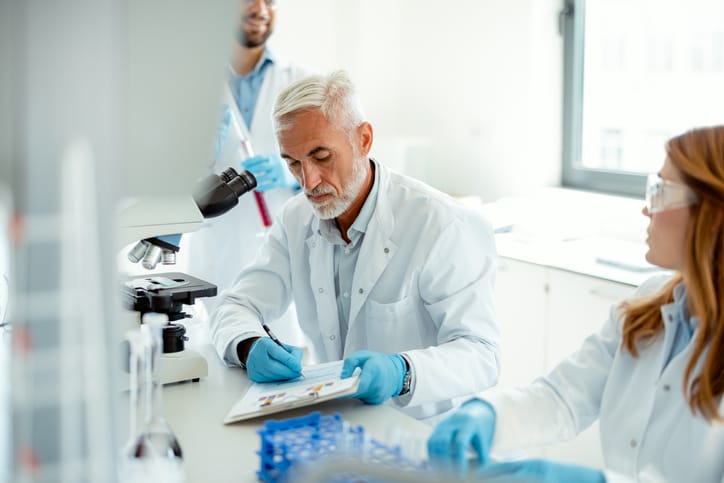 Photo shows a small group of researchers working in a clinical laboratory/Getty Images