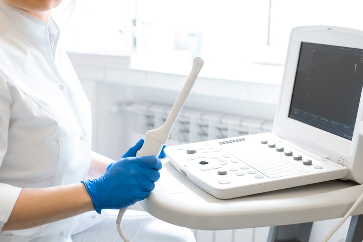 Photo shows a gynecologist setting up an ultrasound machine/Getty Images