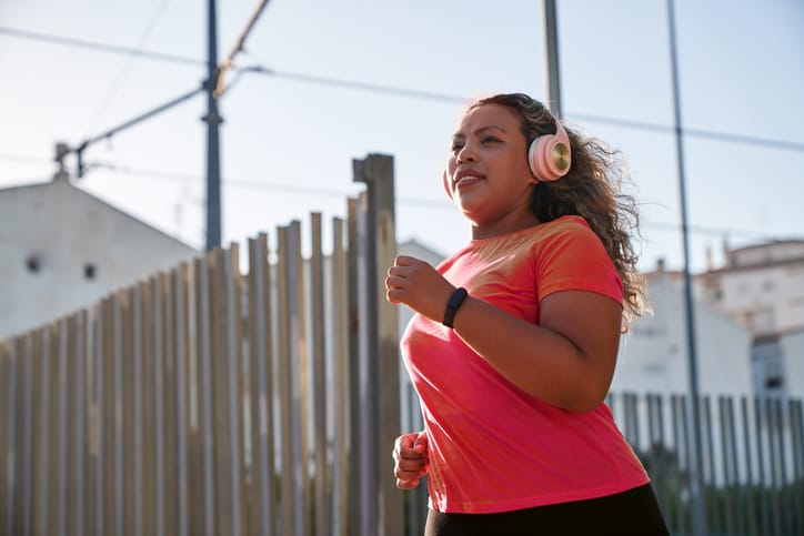 Photo shows a woman running for exercise in a city/Getty Images