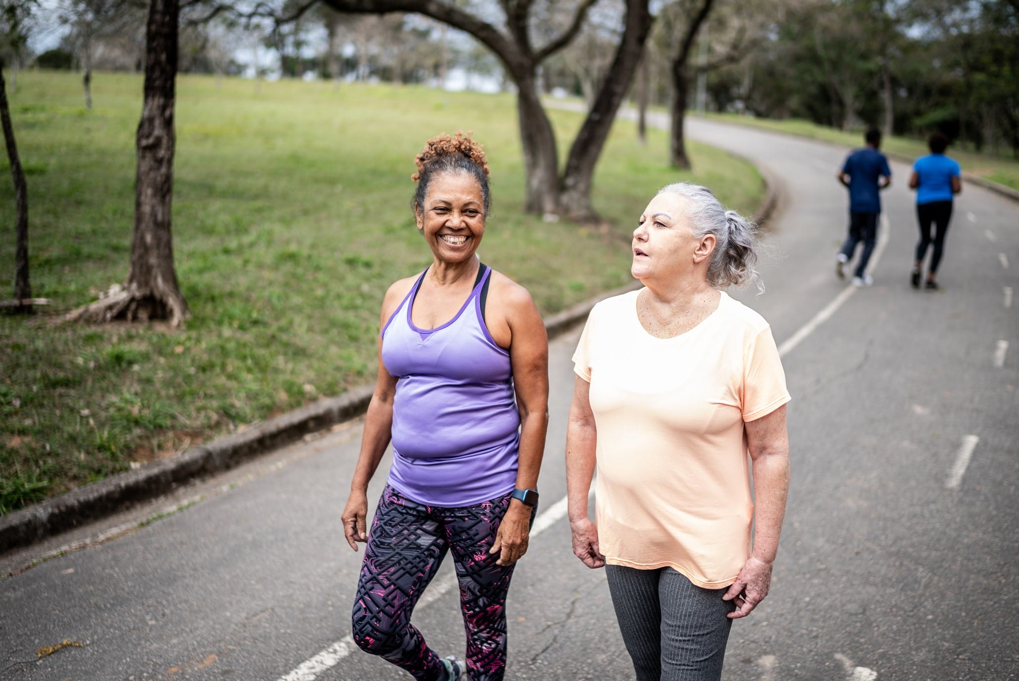 Two middle-aged woman walking on a track