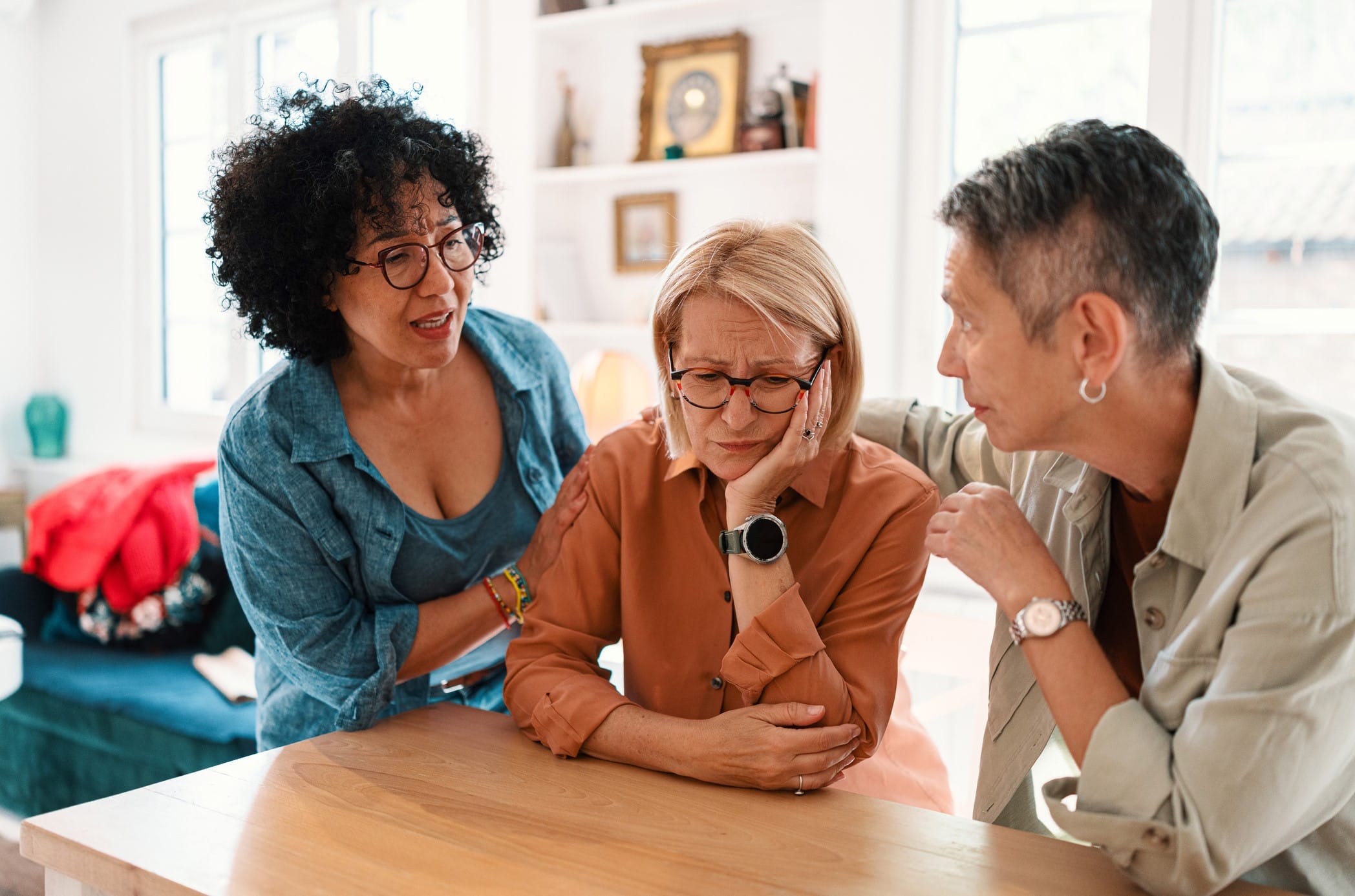 Older women arguing with unhappy woman in middle
